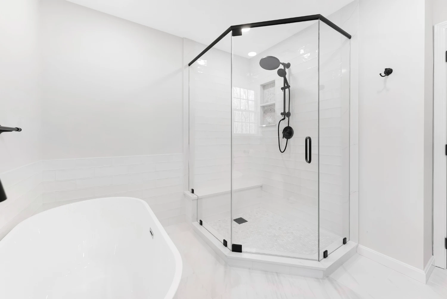 new glass stand up shower with black accents