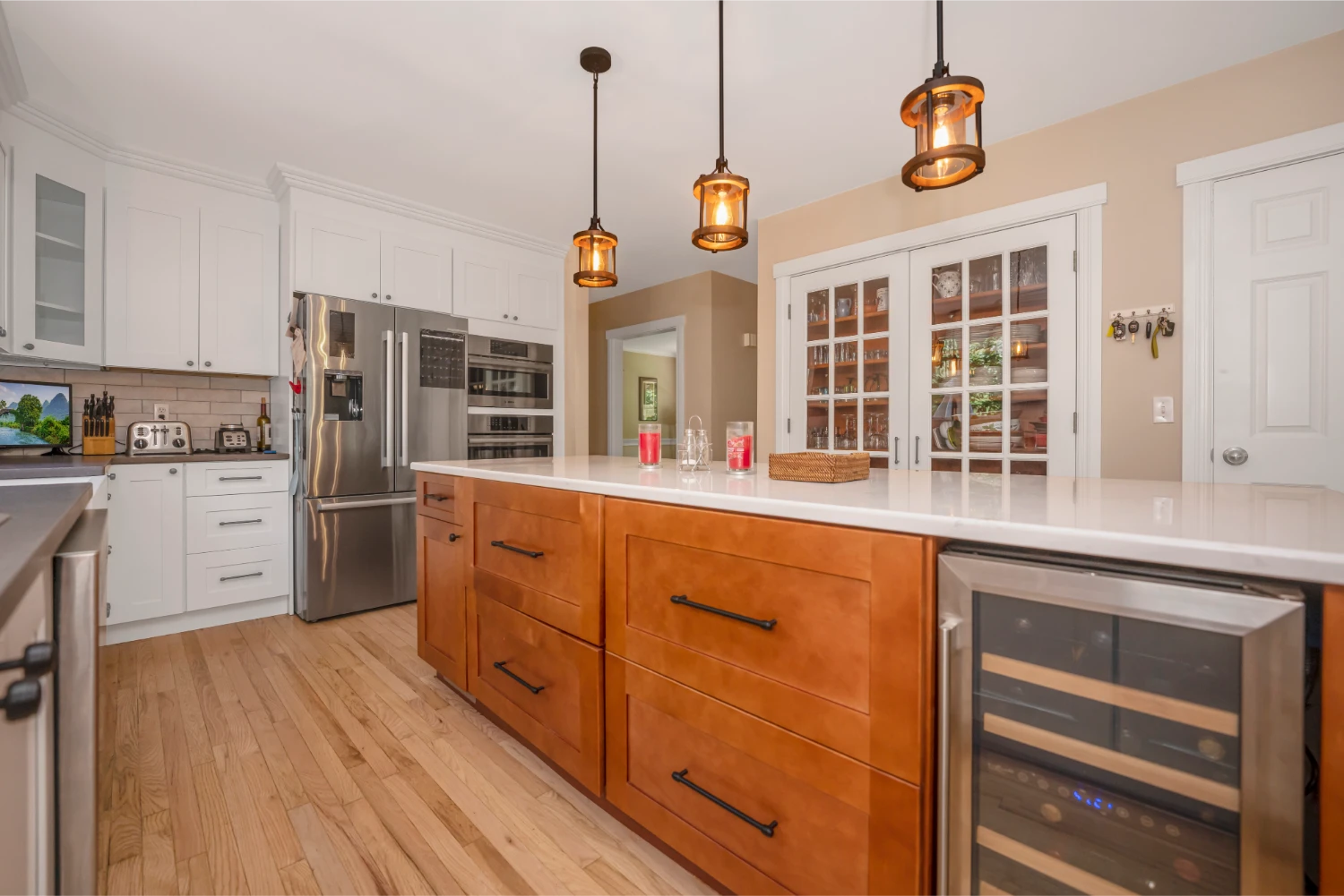 kitchen remodel with pendent lights and warm wood island