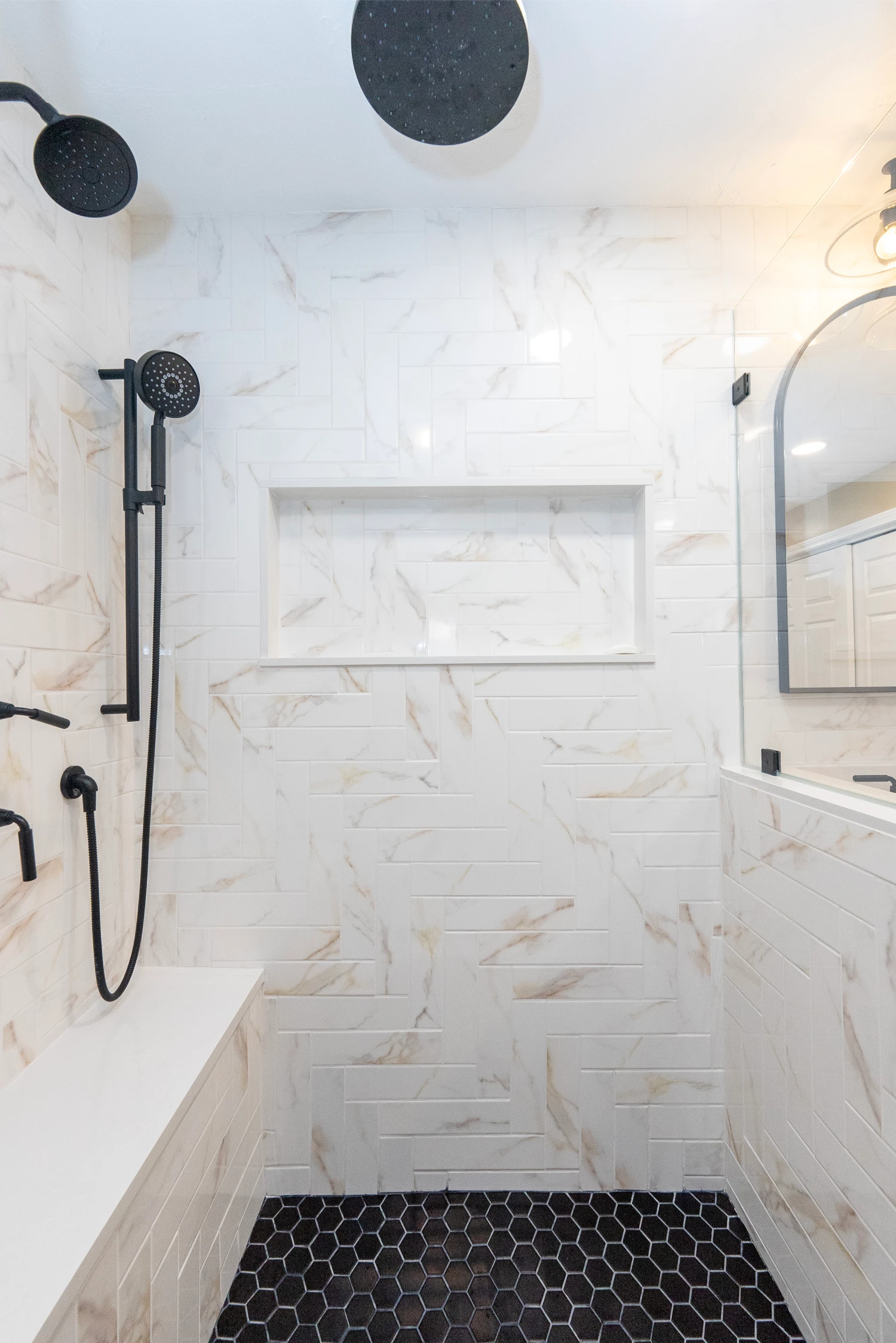custom remodeled stand up shower with harringbone tile pattern